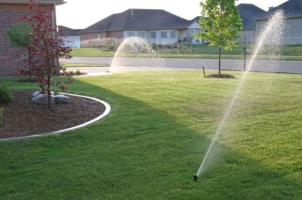 house with healthy grass, deep watering, sprinkler